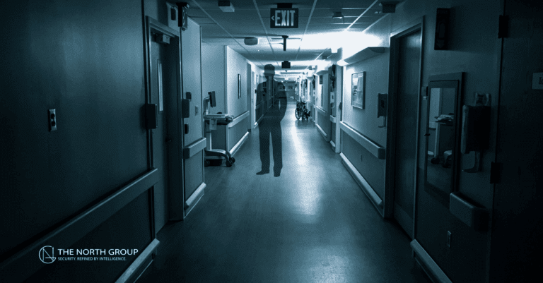 A dimly lit hospital hallway with a semi-transparent, ghostly human figure in the center; doors line both sides and an exit sign is visible.